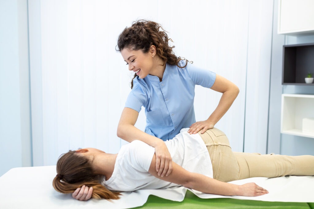 practitioner treating a woman lying on a treatment table